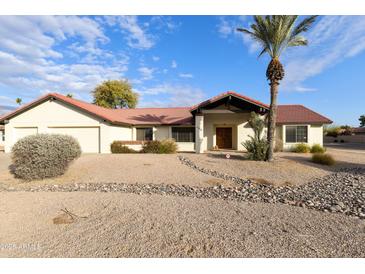 Single-story home with a red tile roof, two-car garage, and desert landscaping at 206 W Caroline Ln, Tempe, AZ 85284