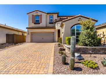 Charming two-story home featuring a desert landscape, a brick driveway, and a two-car garage at 30704 N 138Th Ave, Peoria, AZ 85383