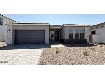 Charming single-story home featuring low maintenance desert landscaping, stone accents, and a two car garage at 11441 E Utah Ave, Mesa, AZ 85212