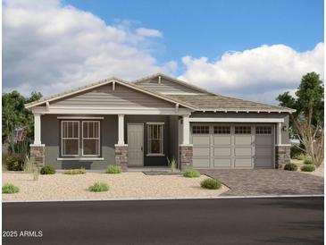 Single-story home with gray siding, stone accents, and a two-car garage at 11464 E Utah Ave, Mesa, AZ 85212