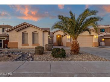 Single-story home with desert landscaping and a two-car garage at 14248 W Edgemont Ave, Goodyear, AZ 85395