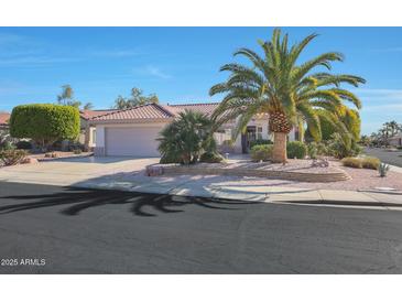 Single-story home with desert landscaping and a two-car garage at 18205 N Divet Ln, Surprise, AZ 85374