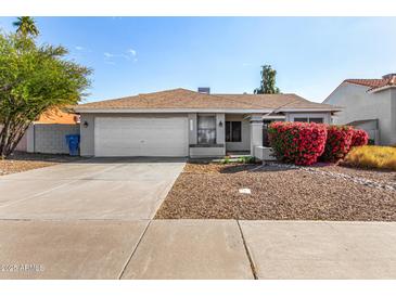 Single-story home with attached garage and landscaped front yard at 18825 N 34Th St, Phoenix, AZ 85050