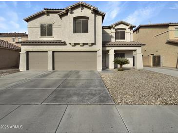 Two-story house with three-car garage and desert landscaping at 2014 N 94Th Gln, Phoenix, AZ 85037