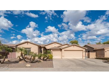 Beautiful desert landscape surrounds this single-story home with a three-car garage at 2147 S Valle Verde Cir, Mesa, AZ 85209