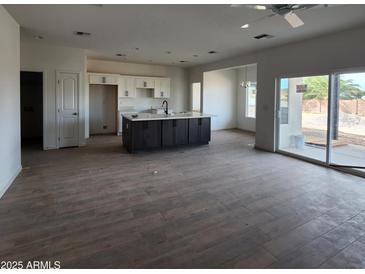 Open kitchen with island, stainless steel appliances, and white cabinets at 22216 W Skinner Rd, Wittmann, AZ 85361