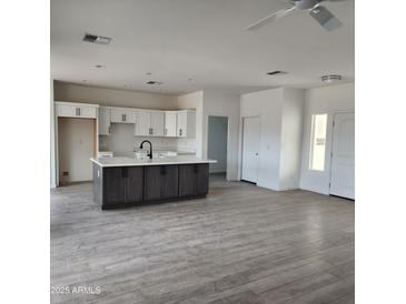 Modern kitchen featuring an island, white cabinets, and gray countertops at 22232 W Skinner Rd, Wittmann, AZ 85361