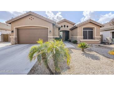 Tan house with brown garage door, landscaping, and a walkway at 2803 E Cobalt St, Chandler, AZ 85225