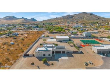 Aerial view of a house with large yard, detached garage, and distant mountains at 2809 W Paso Nuevo Dr, Phoenix, AZ 85086