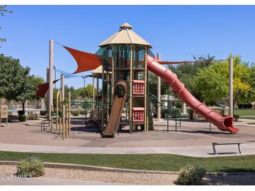 Community playground with a large slide and shade structures at 330 S San Fernando Ln, Casa Grande, AZ 85194