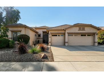 Charming home featuring a three-car garage, desert landscaping, and a welcoming front entrance at 3559 E Bridgeport Pkwy, Gilbert, AZ 85295