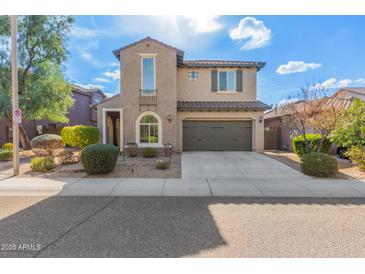 Two-story house with a green garage door and landscaped front yard at 3617 E Half Hitch Pl, Phoenix, AZ 85050