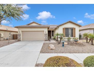 Single-story home with a two-car garage and desert landscaping at 4229 E Seasons Cir, Gilbert, AZ 85297