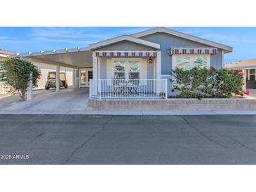 Attractive exterior of a manufactured home with carport and landscaping at 650 N Hawes Rd # 3811, Mesa, AZ 85207