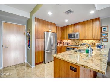 Modern kitchen with stainless steel appliances and granite countertops at 7127 E Rancho Vista Dr # 5009, Scottsdale, AZ 85251