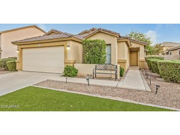 Charming single-story home featuring a well-manicured lawn and a two-car garage at 8219 W Globe Ave, Phoenix, AZ 85043