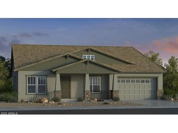 One-story home with green siding, brown roof, and a two-car garage at 8432 W Solano Dr, Glendale, AZ 85305