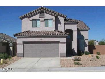 Two-story home with neutral paint, tile roof, two-car garage and low-maintenance gravel landscaping at 934 S Bristol Dr, Mesa, AZ 85208