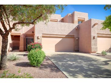 Two-story stucco home with attached garage and landscaping at 1404 W Weatherby Way, Chandler, AZ 85286