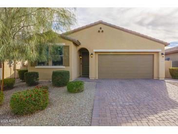 One-story house with a two-car garage and landscaped front yard at 17669 W Daley Ln, Surprise, AZ 85387