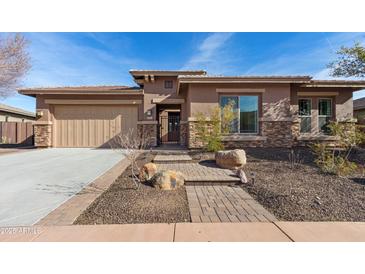 Single-story home with stone accents and a two-car garage at 31689 N 128Th Dr, Peoria, AZ 85383