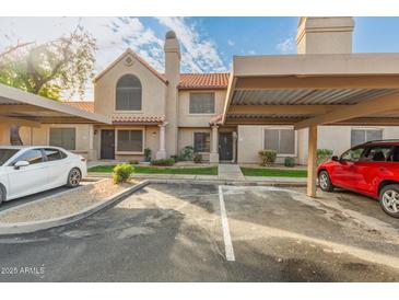 Two-story stucco condo building with covered parking and landscaping at 3491 N Arizona Ave # 98, Chandler, AZ 85225