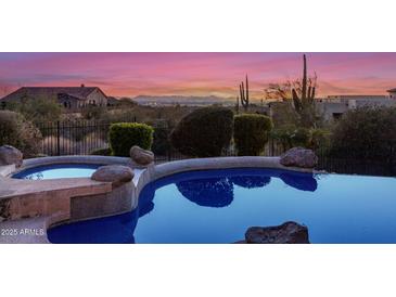 Luxury pool and spa with mountain views at sunset at 4208 N Via Cobre Cir, Mesa, AZ 85207