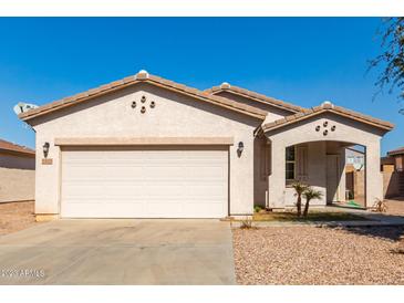 One-story house with a two-car garage and desert landscaping at 7420 W Glass Ln, Laveen, AZ 85339