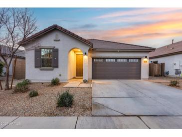 One-story home with attached garage and desert landscaping at 14355 W Desert Hollow Dr, Surprise, AZ 85387