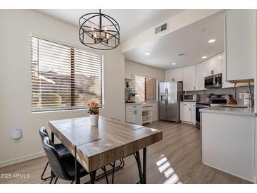 Updated kitchen with eat-in dining area and modern lighting at 15380 N 100Th St # 1096, Scottsdale, AZ 85260