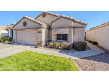 Well-maintained house with a two-car garage and manicured lawn at 17065 N Silver Path, Surprise, AZ 85374