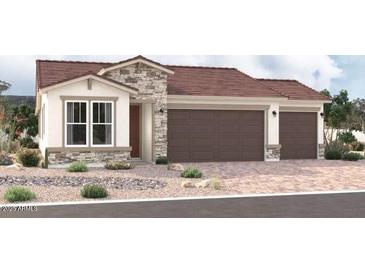 Craftsman style home with three-car garage and red tile roof at 18219 W Hess St, Goodyear, AZ 85338