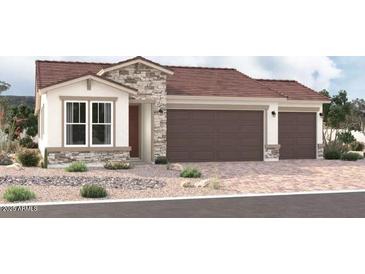 Craftsman style home with three car garage and desert landscaping at 18249 W Hess St, Goodyear, AZ 85338