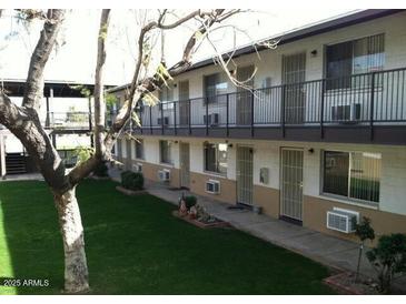 Apartment building with grassy courtyard and covered walkways at 1945 W Sweetwater Ave # 2013, Phoenix, AZ 85029