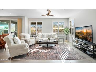 Bright living room features a neutral palette and cozy seating at 2425 W Bronco Butte Trl # 1032, Phoenix, AZ 85085