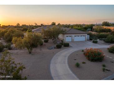 Desert home with three-car garage and circular driveway at 26846 N 73Rd St, Scottsdale, AZ 85266