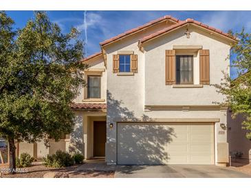 Two-story house with beige exterior, brown shutters, and a two-car garage at 2715 S Sailors Way, Gilbert, AZ 85295