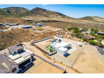 Aerial view of a single-story home with a pool and desert landscaping at 36627 N 18Th Dr, Phoenix, AZ 85086