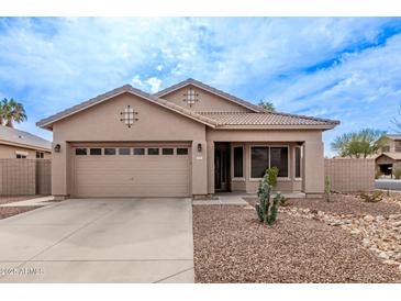 Charming single-story home featuring a two-car garage and desert landscaping at 3711 E Sandy Way, Gilbert, AZ 85297