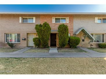 Brick townhouse exterior with well-manicured landscaping and walkway at 5005 S Mill Ave, Tempe, AZ 85282