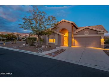 Desert landscape surrounds this charming one-story home with a two-car garage at 6403 S Fairway Dr, Gold Canyon, AZ 85118