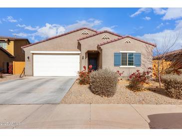 One-story house with a two-car garage and landscaping at 670 E Wiley Way, Casa Grande, AZ 85122