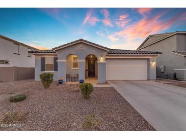 Single-story home with a two-car garage and desert landscaping at 7332 S Briarwood Ln, Gilbert, AZ 85298