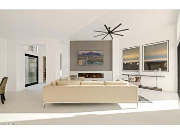 Living room features a neutral color palette, fireplace, and large windows at 7705 E Doubletree Ranch Rd # 39, Scottsdale, AZ 85258