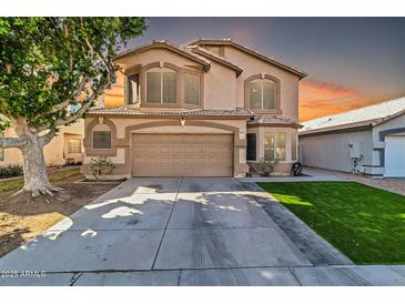 Two-story house with a landscaped lawn and a two-car garage at 906 N Swan Dr, Gilbert, AZ 85234