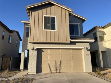 Two-story home with a modern design and attached garage at 9350 E Sequence Ave, Mesa, AZ 85212