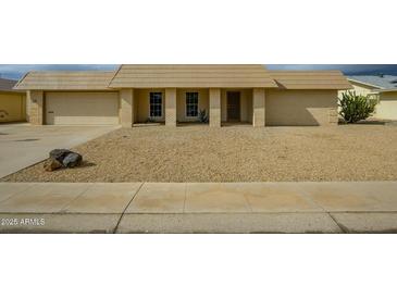 Single story home with attached garage and desert landscaping at 16210 N Desert Holly Dr, Sun City, AZ 85351