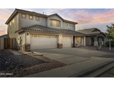 Charming two-story home featuring a three-car garage and desert landscaping at 2338 N 112Th Ln, Avondale, AZ 85392