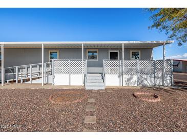 Gray mobile home with covered porch and ramp access at 2650 W Union Hills Dr # 231, Phoenix, AZ 85027