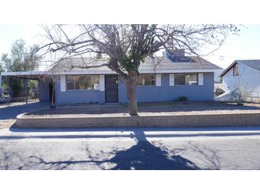 Gray house with a landscaped yard and a carport at 327 W Fairhaven Rd, Kearny, AZ 85137